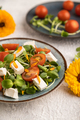 Vegetarian salad of tomatoes, marigold, microgreen, feta cheese on gray. Side view, selective focus. - PhotoDune Item for Sale