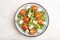 Vegetarian salad of tomatoes, marigold, microgreen, feta cheese on gray. Top view. - PhotoDune Item for Sale