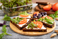 Grain rye bread sandwiches with cream cheese, tomatoes and sorrel microgreen on gray wooden  - PhotoDune Item for Sale