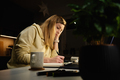 Woman works at home office at night, using laptop - PhotoDune Item for Sale
