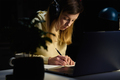 Woman at home workplace using laptop at night - PhotoDune Item for Sale