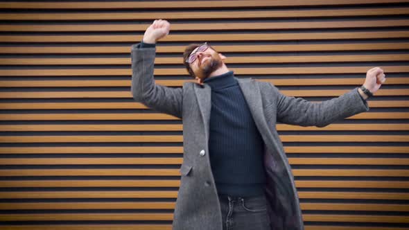 Excited Business Man Dancing Over Street Wall Celebrating Business Achievement