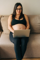 Pregnant business woman working at home on a laptop. - PhotoDune Item for Sale
