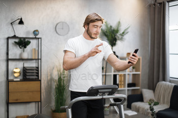 one for video call doing cardio training on treadmill at home or gym showing peace sign. Concept of sport, health care, action, remote leisure.