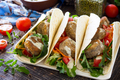 Delicious fresh homemade tortilla wrap with falafel and fresh salad on the table. - PhotoDune Item for Sale