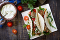 Delicious fresh homemade tortilla wrap with falafel and fresh salad on the table. Vegan tacos. - PhotoDune Item for Sale