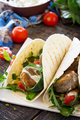 Delicious fresh homemade tortilla wrap with falafel and fresh salad on the table.  - PhotoDune Item for Sale