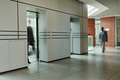 Blurry motion of two male employees in spacious corridor - PhotoDune Item for Sale