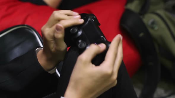 Schoolboy Masterly Managing Video Game's Character Using Finger-Operated Joypad