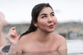 Happy plus size young woman lying down and relaxation in water of outdoors pool at geothermal spa - PhotoDune Item for Sale