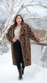 Full length portrait of woman in fur coat with leopard pattern, black jeans and high boots standing - PhotoDune Item for Sale