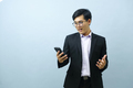 Portrait of surprised businessman holding mobile phone. - PhotoDune Item for Sale
