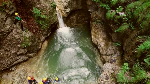 Aerial view of kid jumping into the water in Soca river, Slovenia