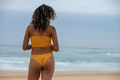 Rear view of woman seen standing at the beach - PhotoDune Item for Sale