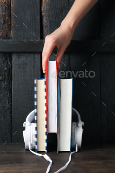 Concept of audiobook with books and headphones