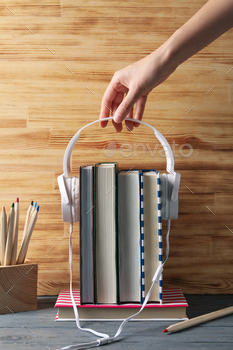 Concept of audiobook with books and headphones