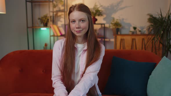 Closeup of Happy Beautiful Young Redhead Child Girl Smiling Looking at Camera at Home on Couch