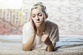 Relaxed woman using a smart phone in the morning on the bed at home - PhotoDune Item for Sale
