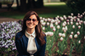Portrait of a smiling brunette, looking at the camera, flowers behind. - PhotoDune Item for Sale
