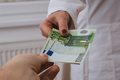 A female doctor getting paid by the euros. - PhotoDune Item for Sale