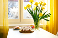 Easter cake, eggs and bunch of narcissus on a table - PhotoDune Item for Sale