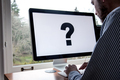 Using computer with large question mark on screen - PhotoDune Item for Sale