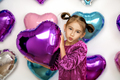 Girl holds balloon in hands and sends an air kiss on Valentine's Day - PhotoDune Item for Sale