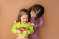 Sister comforts little crying girl holding heart with puzzles in hands - PhotoDune Item for Sale