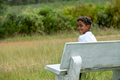 Portrait of boy seen sitting on bench in nature - PhotoDune Item for Sale