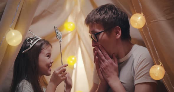 Close Up of Father and Daughter Talking and Laughing Inside of Teepee