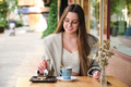 Woman eating a cake and drinking coffee in a cafe. - PhotoDune Item for Sale