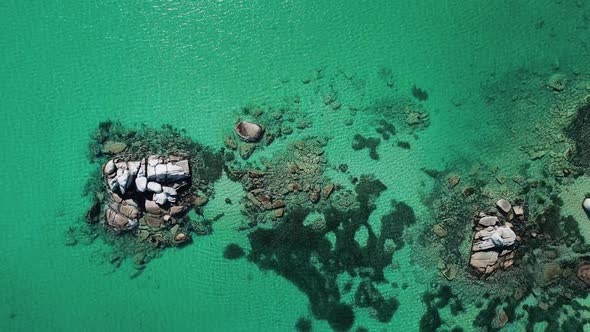 Aerial Top Down View of Huge Rocks in the Sea and Turquoise Water