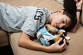 Teenager boy with sleep cat in a bandage after surgery. - PhotoDune Item for Sale