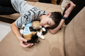 Teenager boy with sleep cat in a bandage after surgery. - PhotoDune Item for Sale