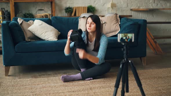 Pretty Young Woman Is Recording Video About Artificial Reality Glasses Holding Gadget and Talking