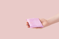 Sanitary pad in female hand against pink background - PhotoDune Item for Sale