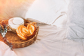 Wicker tray with croissants and coffee on white bed linen - PhotoDune Item for Sale