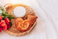 Wicker tray with pastries and coffee and flowers on white bed linen - PhotoDune Item for Sale