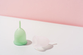 Menstrual cups on a white table against a pink background - PhotoDune Item for Sale