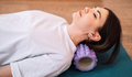 Lady massaging her neck with a purple massage roller - PhotoDune Item for Sale