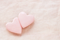 Two pastel pink hearts on pink linen background. - PhotoDune Item for Sale