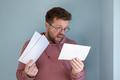 Man looks at gas bills, he is shocked by rising prices. Concept of the energy crisis. - PhotoDune Item for Sale