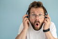 Funny man in headphones listens to music, he is surprised at what he hears - PhotoDune Item for Sale