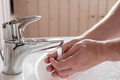 Man washes hands under a stream of clean running water, over the sink, in the bathroom - PhotoDune Item for Sale