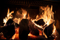 Fire and burning firewood in an iron fireplace to heat a house during an energy crisis  - PhotoDune Item for Sale