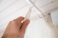 Hand closes a waterproof curtain in the bathroom, which covers the shower and prevents moisture - PhotoDune Item for Sale