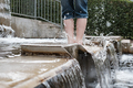 Barefoot child runs merrily along clear running water in the form of a waterfall - PhotoDune Item for Sale