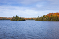 Blue lake with an island in northern Minnesota with trees in autumn color along the shore - PhotoDune Item for Sale