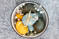 Multicolored Easter eggs in a bowl, closeup top view. Festive decoration. - PhotoDune Item for Sale