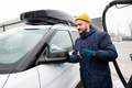 Man wipes american SUV car mirror with a microfiber cloth after washing in cold weather. - PhotoDune Item for Sale